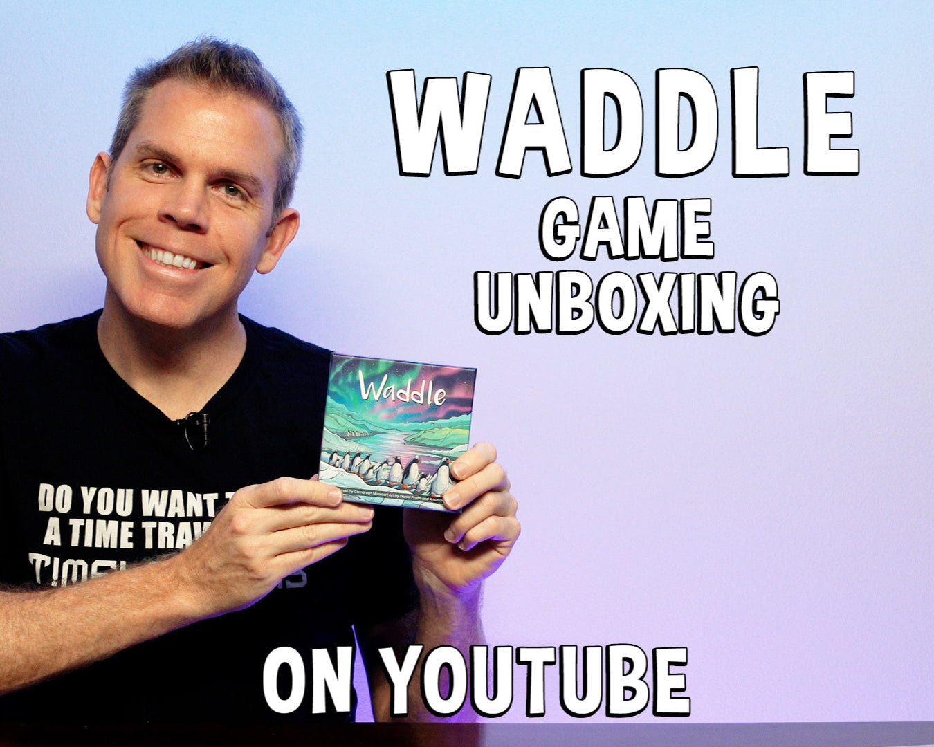 Man holding a 'Waddle' game box with text about an unboxing on YouTube.